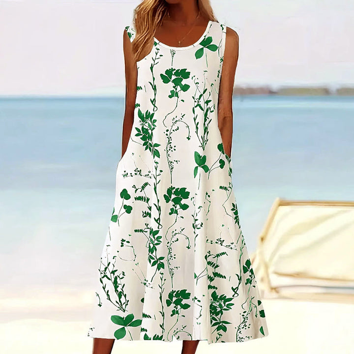 Casual women's A-line midi dress featuring a vibrant floral print, sleeveless design, and essential side pockets.