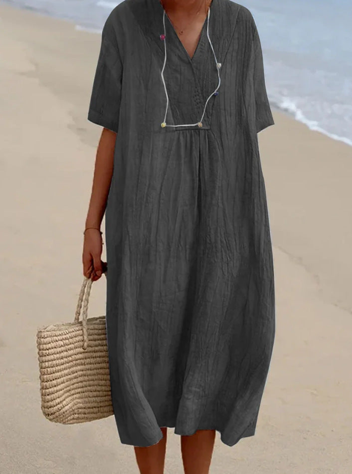 Chic women's V-neck A-line midi dress. Flattering silhouette & short sleeves for elegant, comfortable wear.