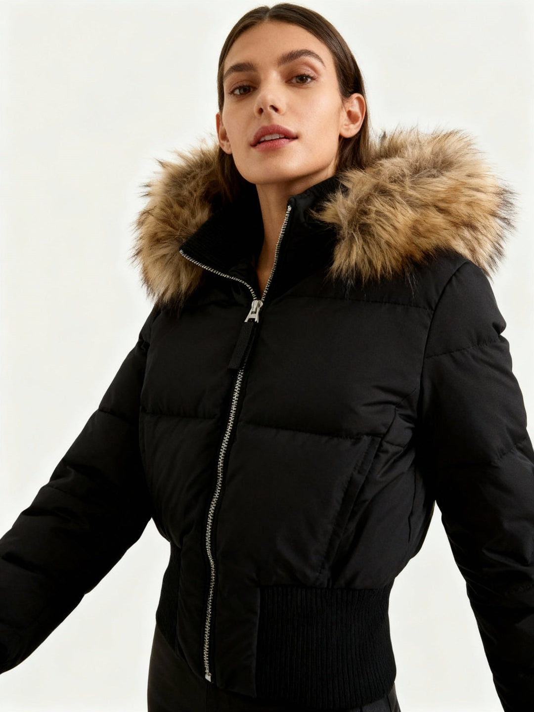 Women's quilted winter jacket with warm faux fur hood for cold weather.