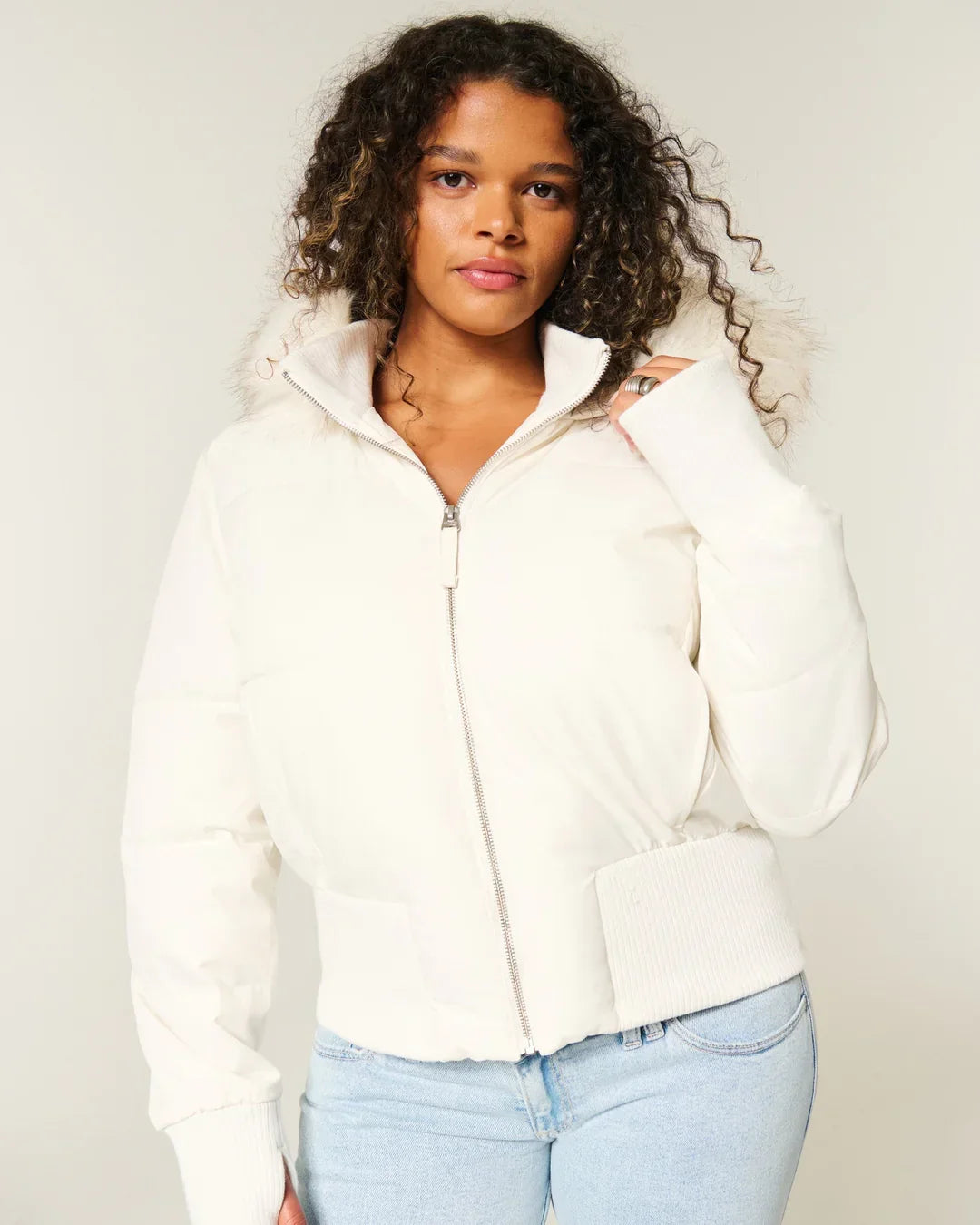 Fashionable women's hooded puffer, warm and quilted, with a stylish faux fur trim.