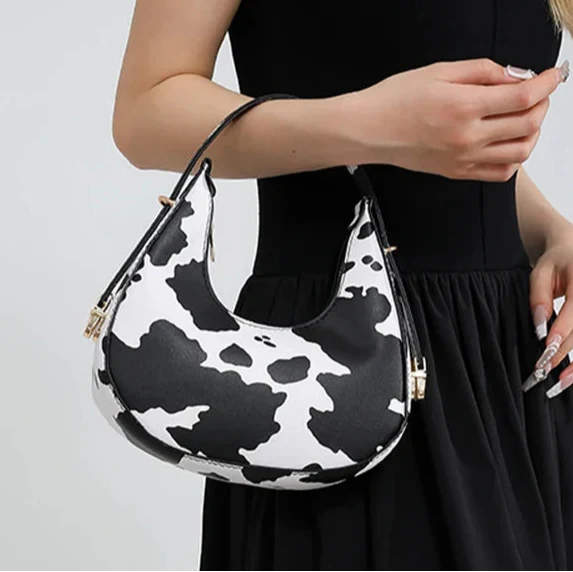 Chic women's animal print faux leather shoulder bag, a fashionable crescent handbag with a zipper.