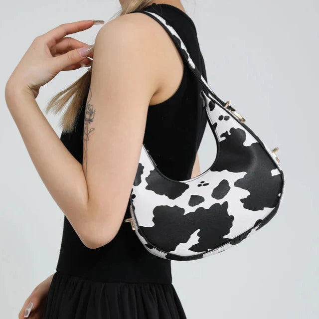 Trendy animal print shoulder bag for women, faux leather crescent design, perfect fashion accessory with zipper.