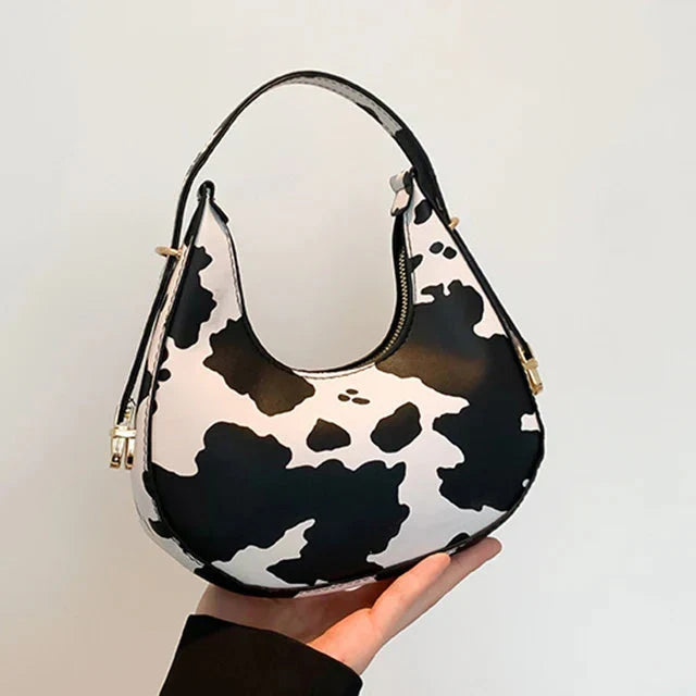 Stylish women's animal print shoulder bag, faux leather crescent handbag with secure zipper closure.