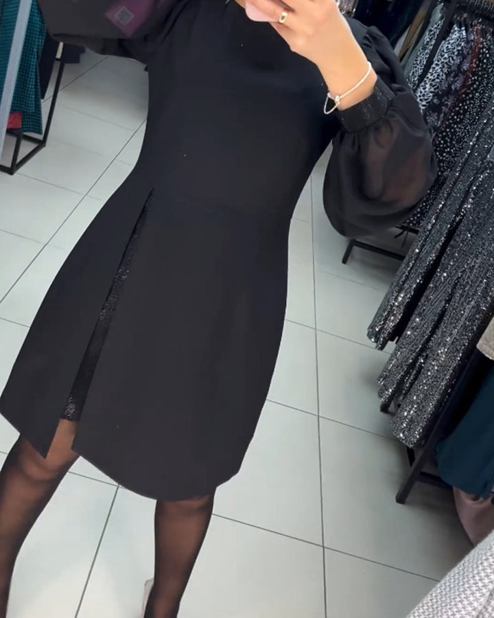 Elegant black mini dress for women, featuring sophisticated sheer sleeves and a thigh-high slit, ideal for cocktails.