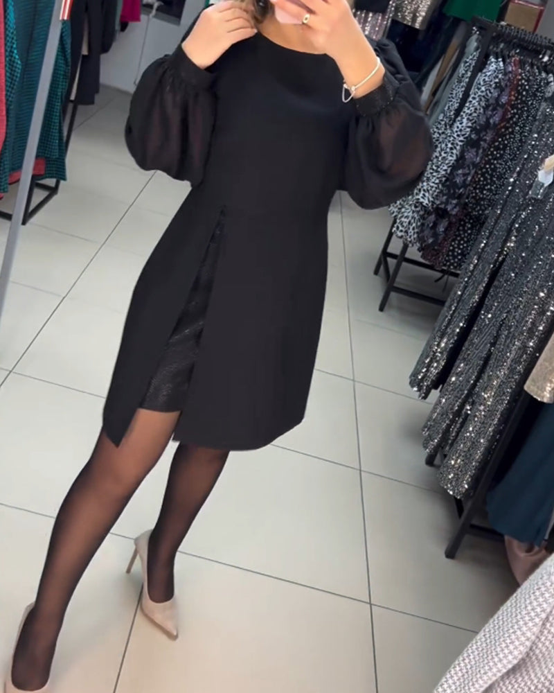 Sophisticated women's black party dress, a mini length with elegant sheer long sleeves and a trendy slit detail.