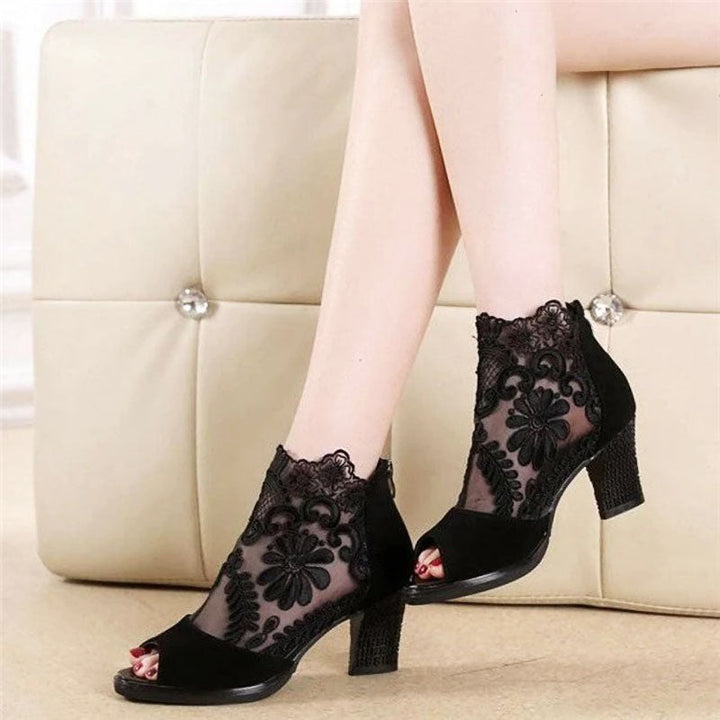 Women's black peep toe high heels with a stylish floral mesh ankle strap; ideal for dress, formal, or evening events.