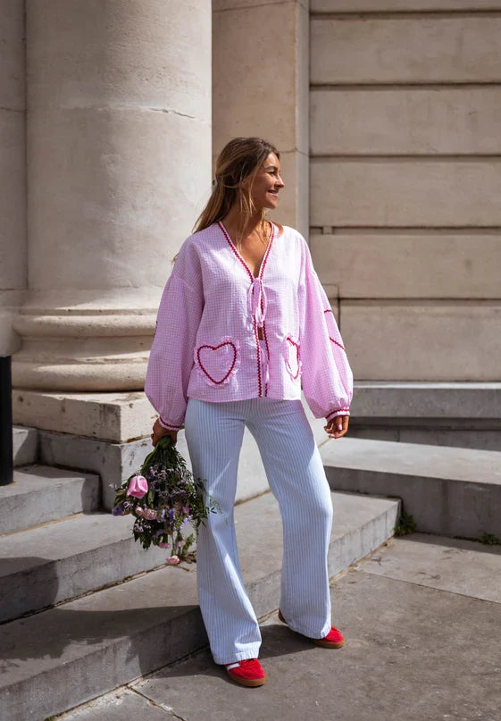Elegant long-sleeve women's blouse with chic puff sleeves and ruffle trim. Versatile fashion top.