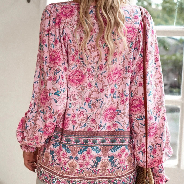 Elegant long sleeve women's blouse with vibrant floral print and a sophisticated tie neck design.