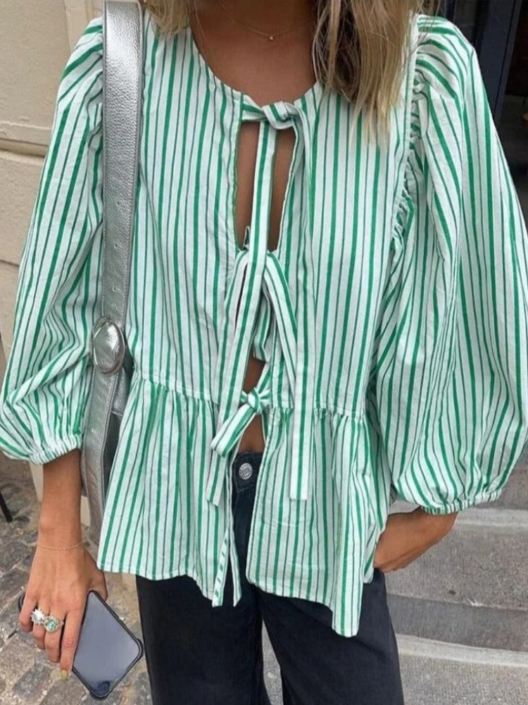 Elegant women's blouse with delicate puff sleeves & fashionable tie front detail.
