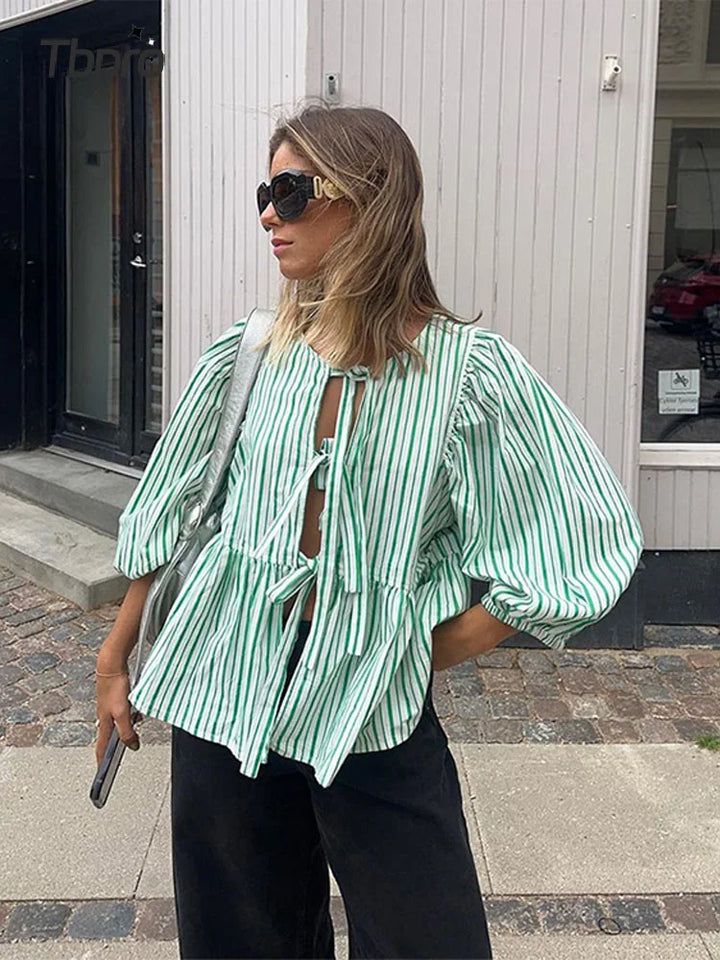 Women's chic tie front blouse with elegant puff sleeves. Perfect for a stylish look.