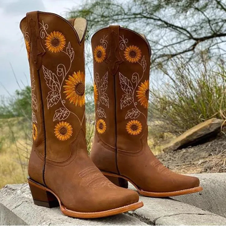 Embroidered women's western boots in brown, showcasing vibrant sunflower design. Square toe fashion boots.