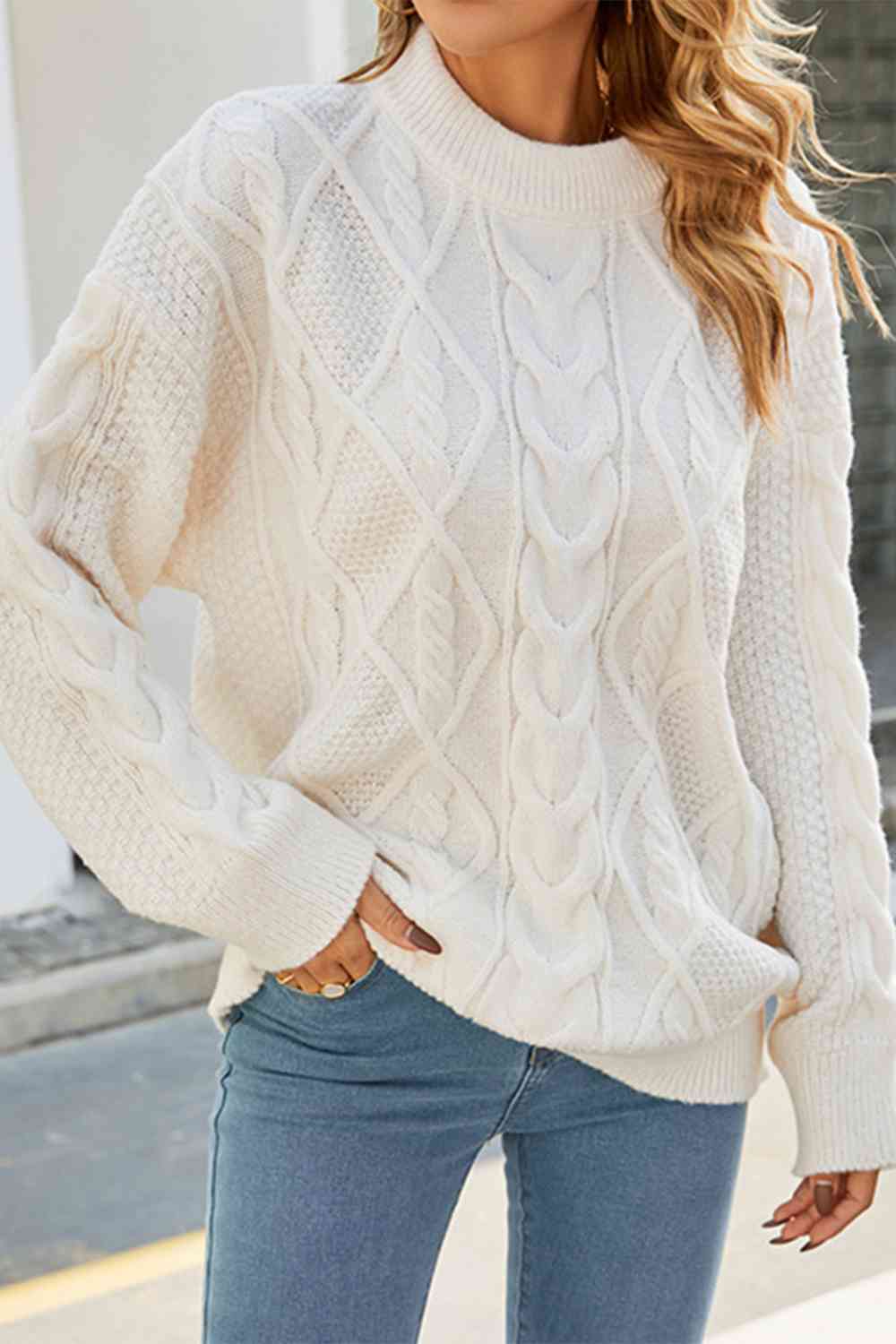 Women's oversized cable knit crew neck jumper, a cozy winter pullover for a relaxed fit.