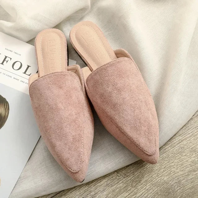 Elegant women's slip-on mules with a sharp pointed toe, ideal footwear for sophisticated casual or office wear.