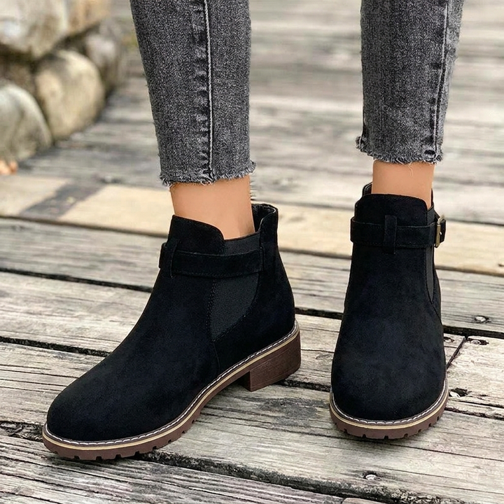 Stylish women's brown Chelsea ankle boots, pointed toe, western flair, comfortable block heel & decorative buckle strap.