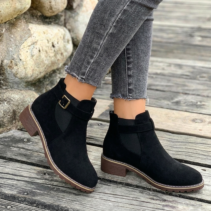 Comfortable grey Chelsea ankle boots for women, featuring a practical block heel, buckle strap, and versatile design.