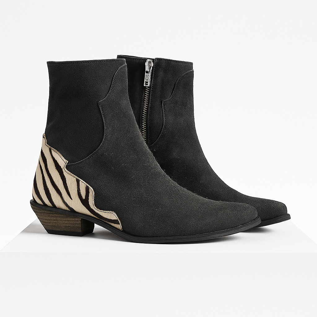 Sleek black women's Chelsea ankle boots featuring a striking zebra print heel, offering stylish versatility.