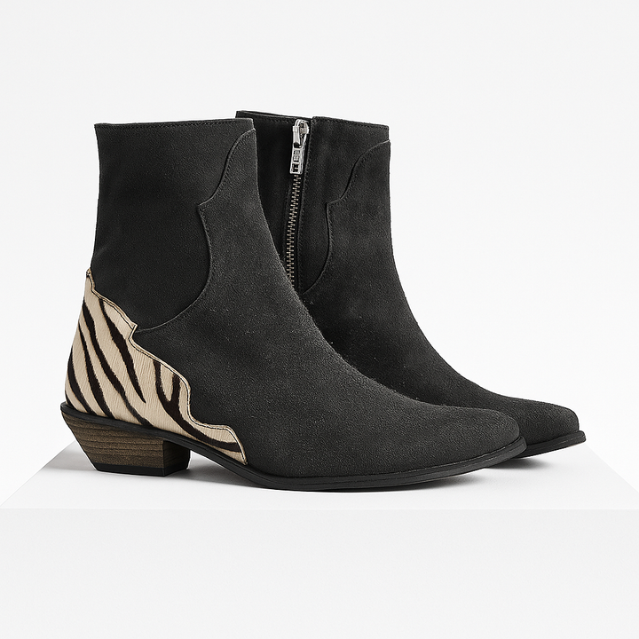 Sleek black women's Chelsea ankle boots featuring a striking zebra print heel, offering stylish versatility.