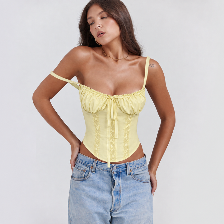 Black cropped corset top for women, featuring a flattering ruffle bust and adjustable tie front.