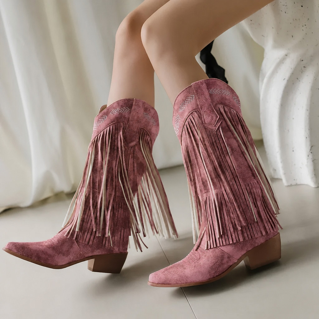 Close-up of white fringe cowgirl boots showing detailed western embroidery & block heel. Trendy women's boots.