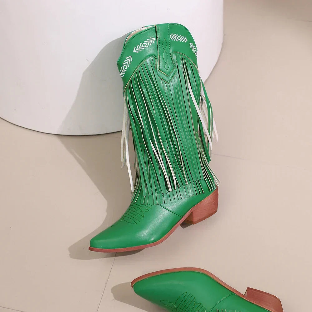 Detailed view of green western boots with fashionable fringe, intricate embroidery, & a trendy block heel.