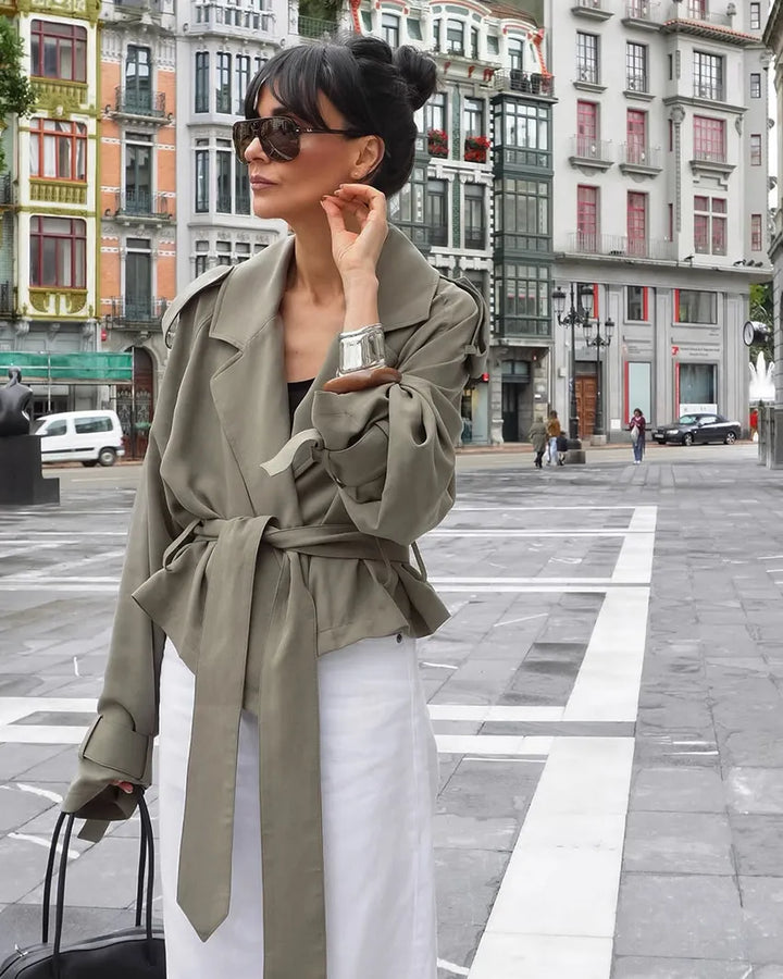 Casual chic women's olive green cropped trench coat with a tie belt & notched lapel, a perfect spring/fall layering piece.