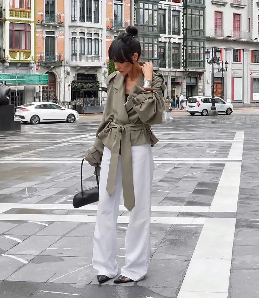 Modern women's cropped trench coat in olive green, featuring a chic tie belt and sophisticated notched lapel design.