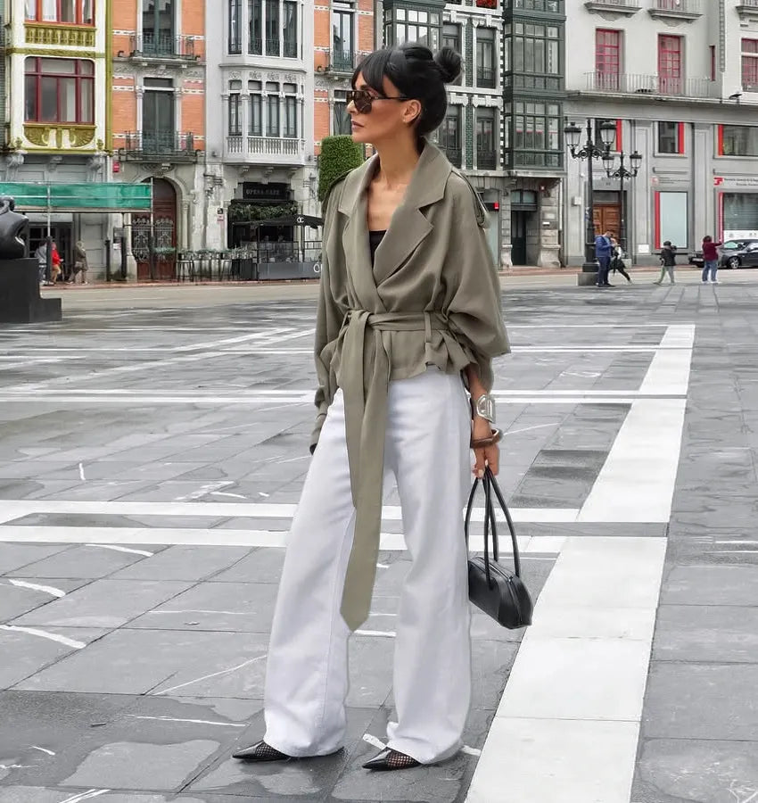 Versatile women's olive green cropped trench coat with a functional tie belt & classic notched lapel. Great for layering.