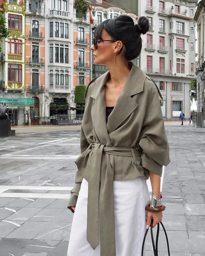 Women's olive green cropped trench coat with a chic tie belt & stylish notched lapel, ideal for spring fashion.