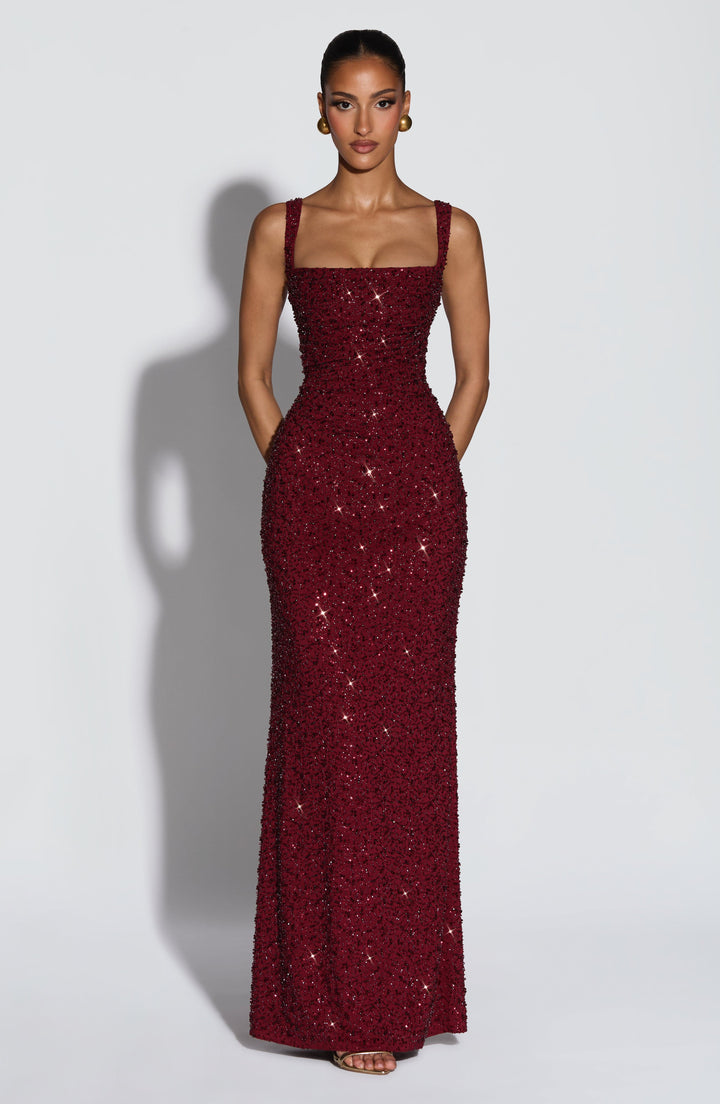 Elegant women's burgundy sequin maxi prom dress with a flattering square neckline, perfect for formal events.