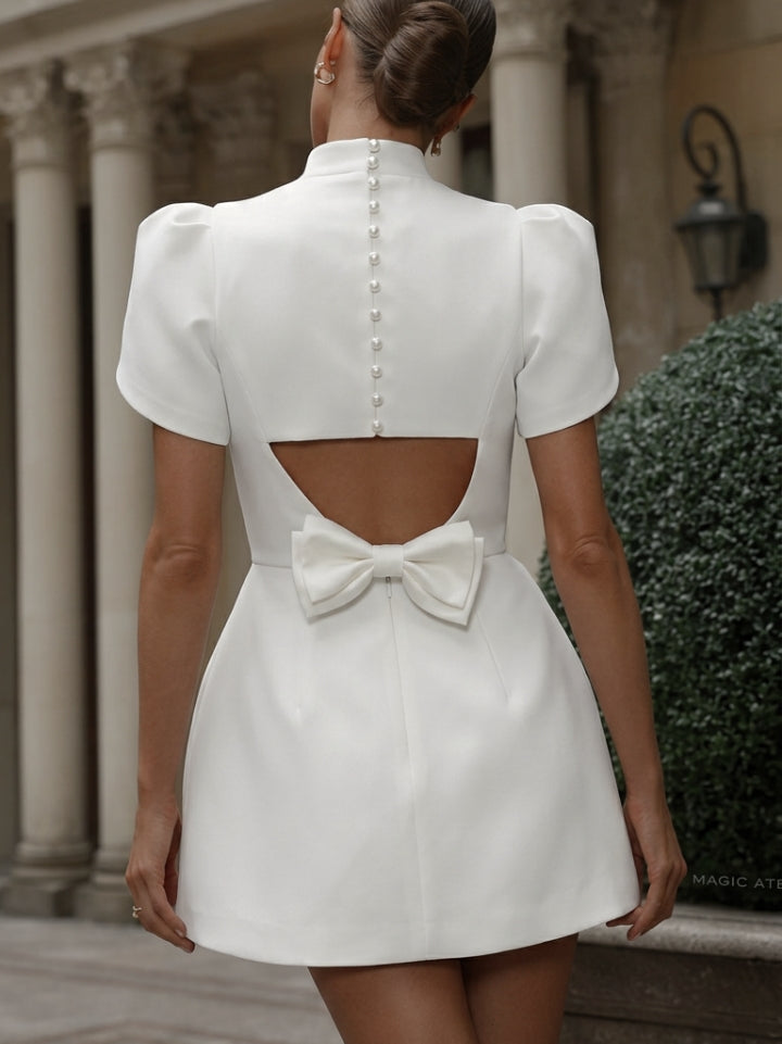 Stylish white mini dress for women with a sophisticated mock neck and elegant puff sleeves, great for parties.