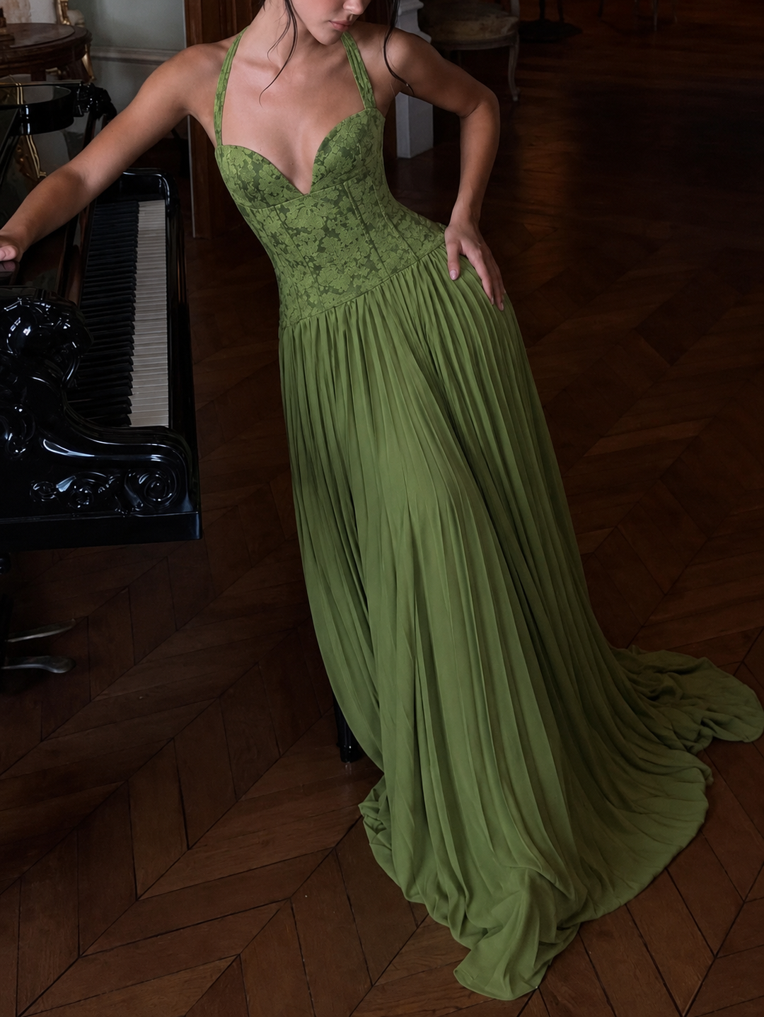 Long elegant women's halter neck corset dress featuring a pleated maxi skirt & alluring lace-up back detail.