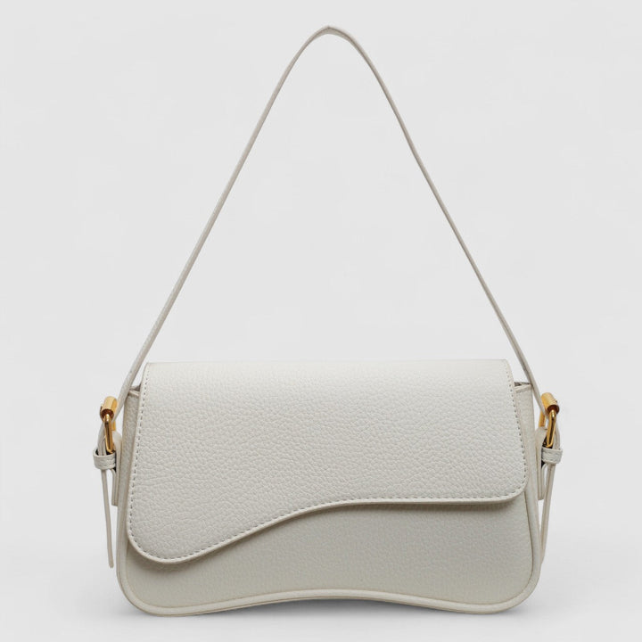Chic women's structured shoulder bag with unique wave flap. A stylish and elegant everyday handbag accessory.