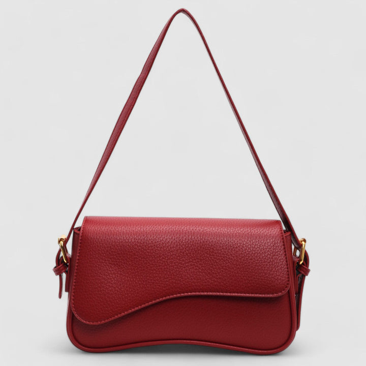Elegant women's structured shoulder bag featuring a distinctive wave flap, a modern and chic fashion accessory.