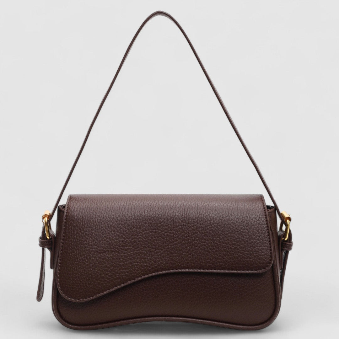 Women's sophisticated structured shoulder bag with a unique wave flap design. A versatile and elegant handbag.