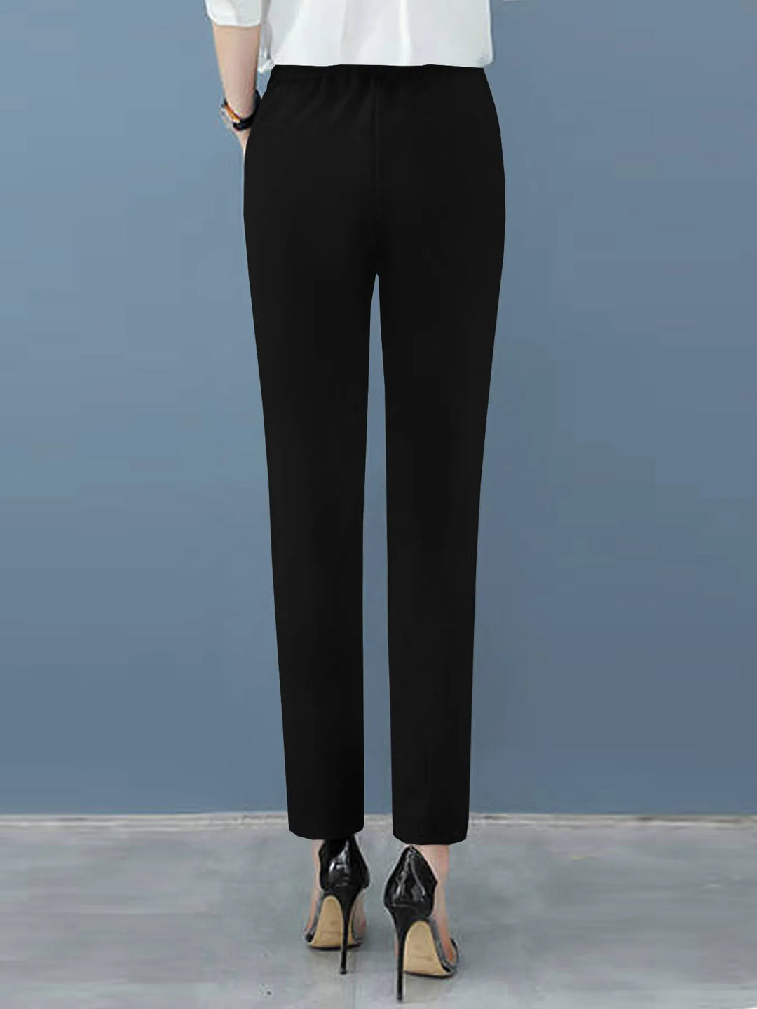 Chic women's workwear, high-waisted pleated dress pants with a flattering tapered leg, perfect for the office.