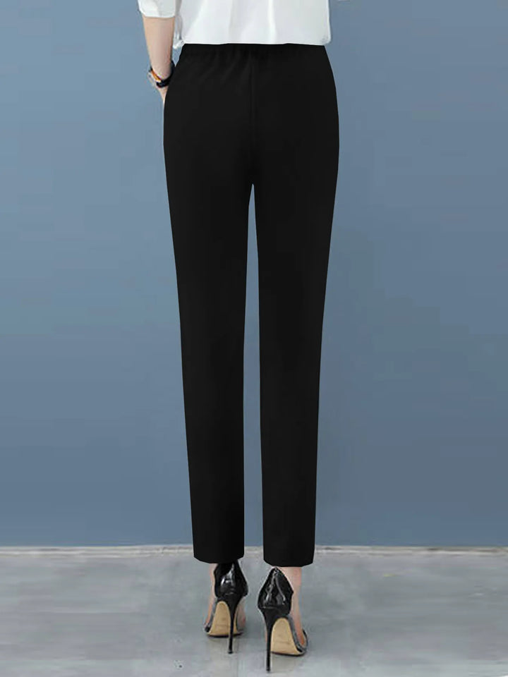 Chic women's workwear, high-waisted pleated dress pants with a flattering tapered leg, perfect for the office.