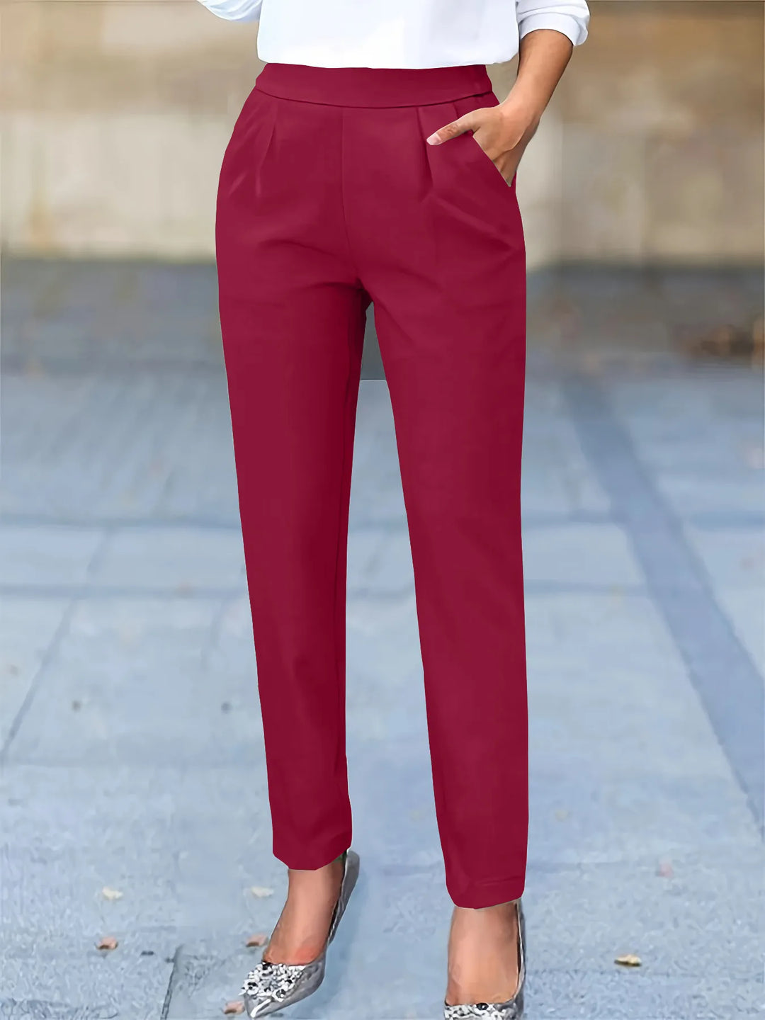 Professional women's tapered fit pants featuring a high waist, pleats, and convenient pockets for work.