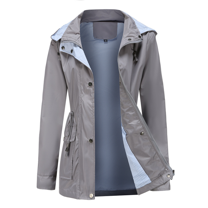 Women's long rain jacket, hooded, with a snap front and striped lining, perfect for casual and coastal wear.