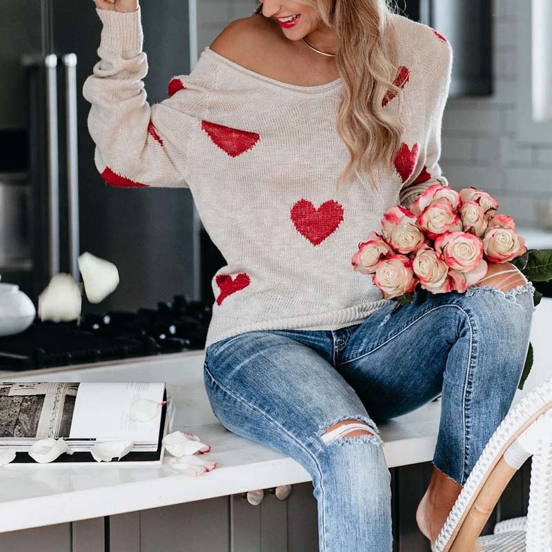 Cozy women's V-neck knit sweater with heart print. Long sleeve, great for winter days.