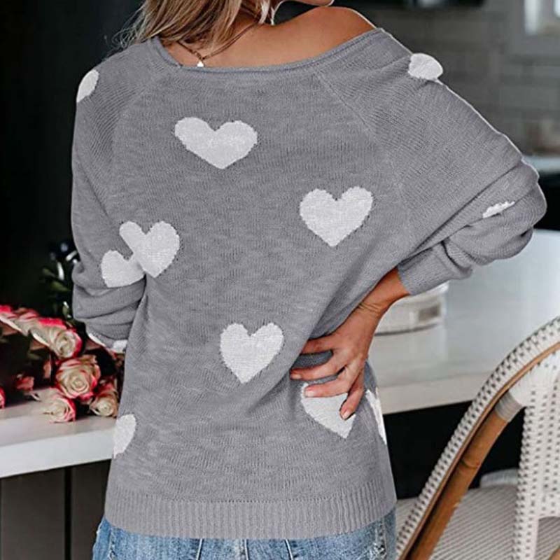 Women's V-neck knitwear with charming heart print. Long sleeve, perfect for cozy outfits.