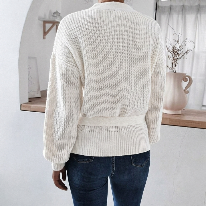 Relaxed fit women's knitted jumper. Features a flattering wrap front and adjustable tie waist, ideal for winter.