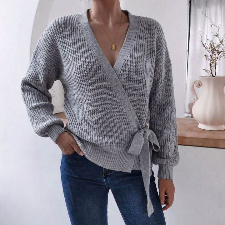 Stylish women's sweater, a comfy knitted jumper with a unique wrap front and chic tie waist detail.