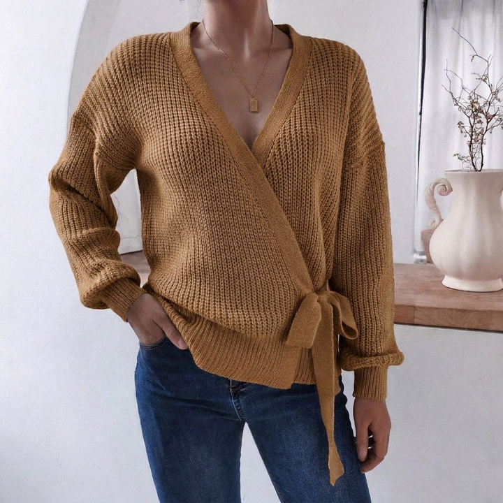 Modern women's wrap front knitted jumper with a tie waist, offering a relaxed fit and versatile style.