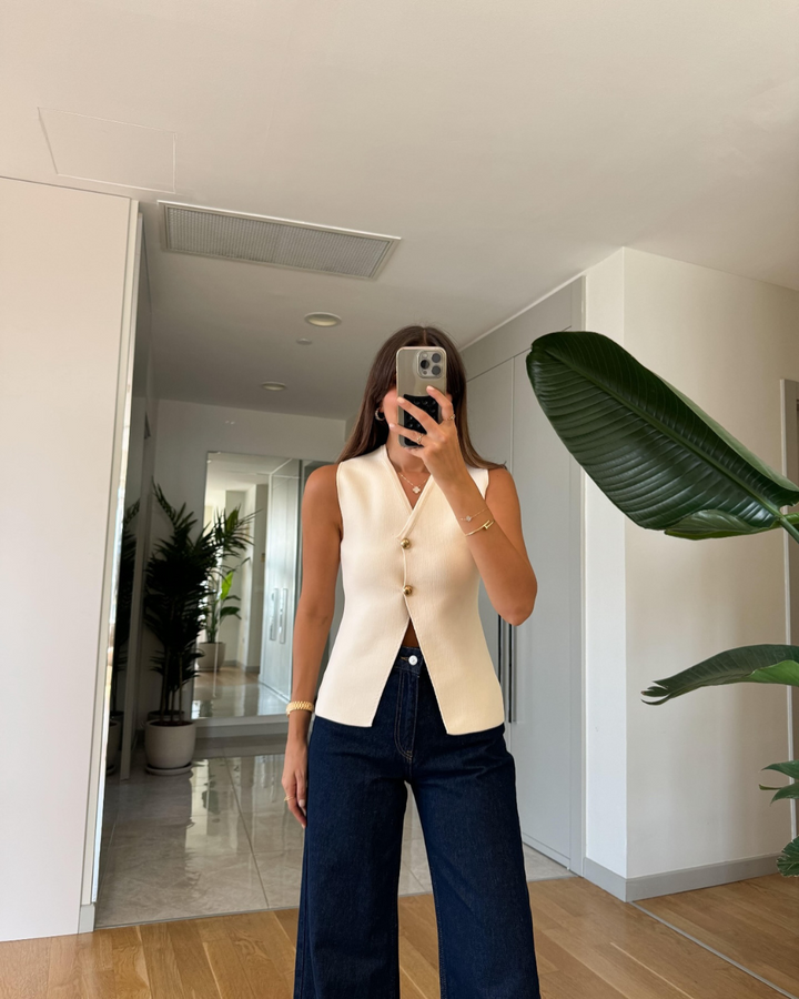 Stylish women's V-neck knitted vest with button front. Ideal for modern office style and versatile fashion.