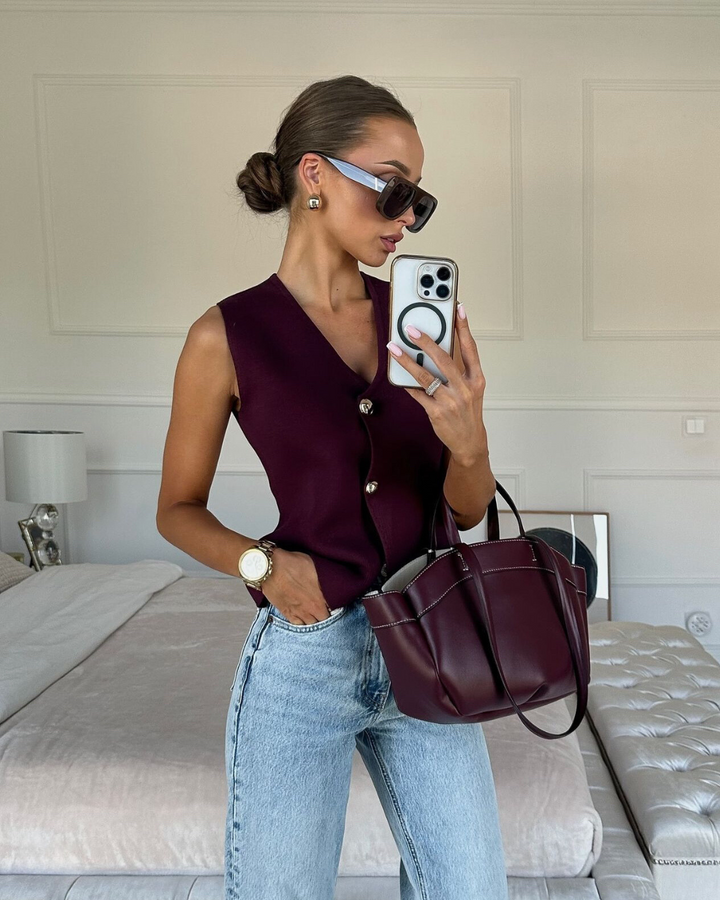 Modern women's button-front V-neck knitted vest, a versatile sleeveless top for chic daily outfits.