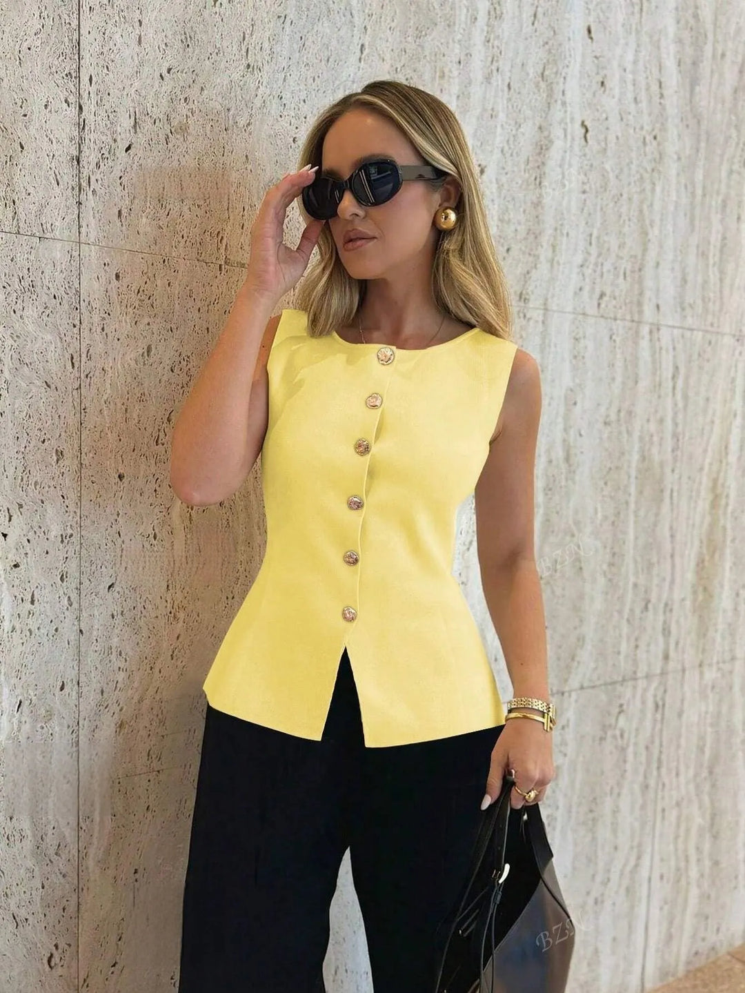 Fashionable women's sleeveless tailored vest, knitted, with a button-front & trendy split hem. Smart casual look.