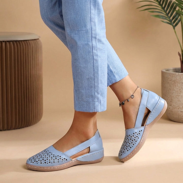 Slip-on women's loafers with a perforated design and side cut-outs, offering breathable comfort for casual footwear.