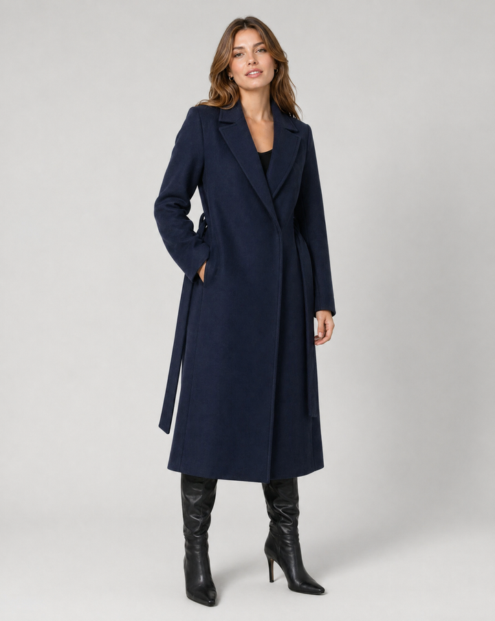 Stylish women's long jacket. Elegant outerwear, a sophisticated trench coat with tie belt & notched lapel.