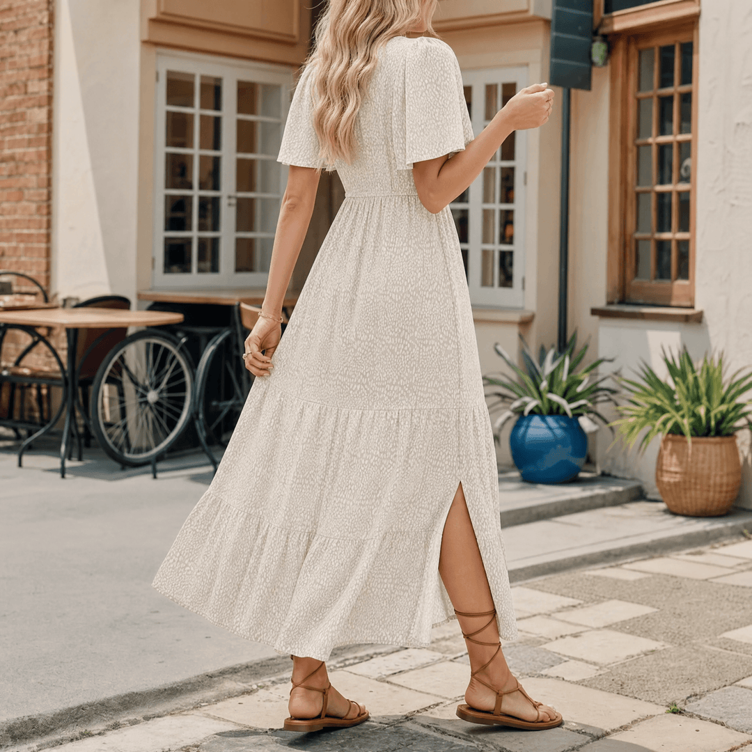 Women's smocked maxi dress, a long summer dress with flutter sleeves, side slit, and a tiered skirt design.