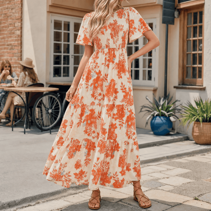 Stylish women's smocked maxi dress with flutter sleeves, side slit, and a comfortable, elegant fit.